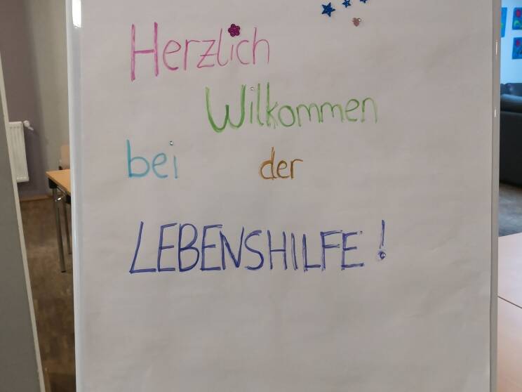 Bild eins zeigt ein Willkommensplakat